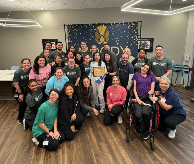 Philosophy Female patient in wheelchair outside having a conversation with another female at Moody Neuro Institute